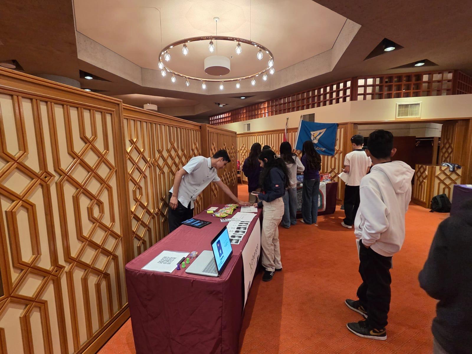 XChange booth — helping students at the table